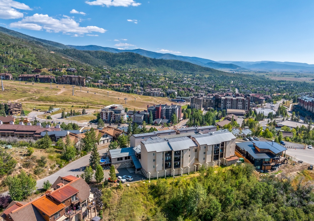 A mountain resort community nestled in a scenic valley, surrounded by forested slopes and expansive natural beauty.