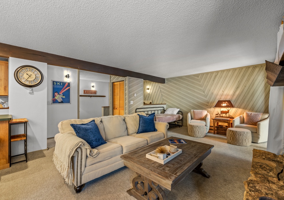 Unwind in your cozy living space featuring rustic wood accents, plush seating, and warm lighting that creates the perfect mountain retreat atmosphere.
