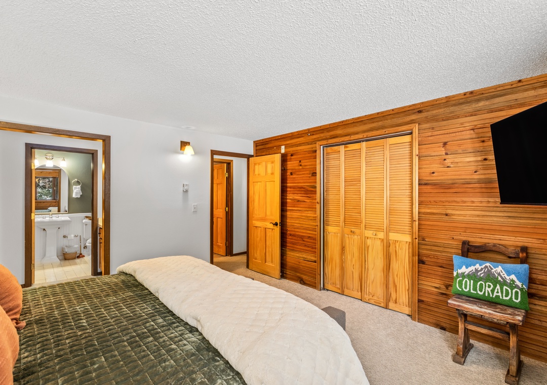 Rest peacefully in your cozy primary bedroom with warm wood accents, plush bedding, and mountain-themed touches that celebrate Colorado's natural beauty.