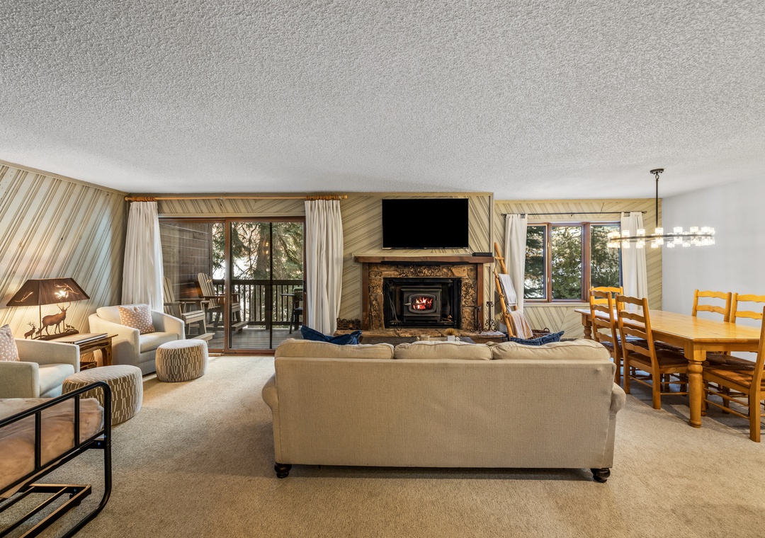 Unwind in your spacious living area with cozy fireplace, mountain views, and open dining space perfect for memorable meals.