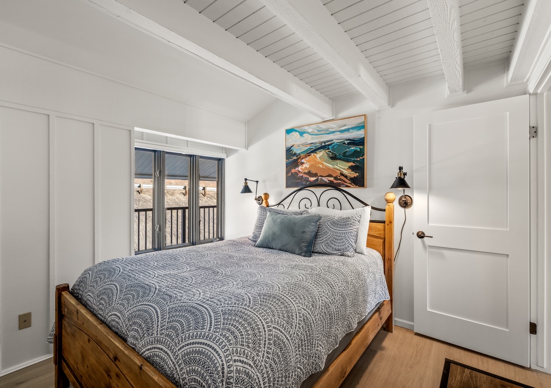 Drift off in your cozy main level bedroom with charming exposed beams, and soft linens.
