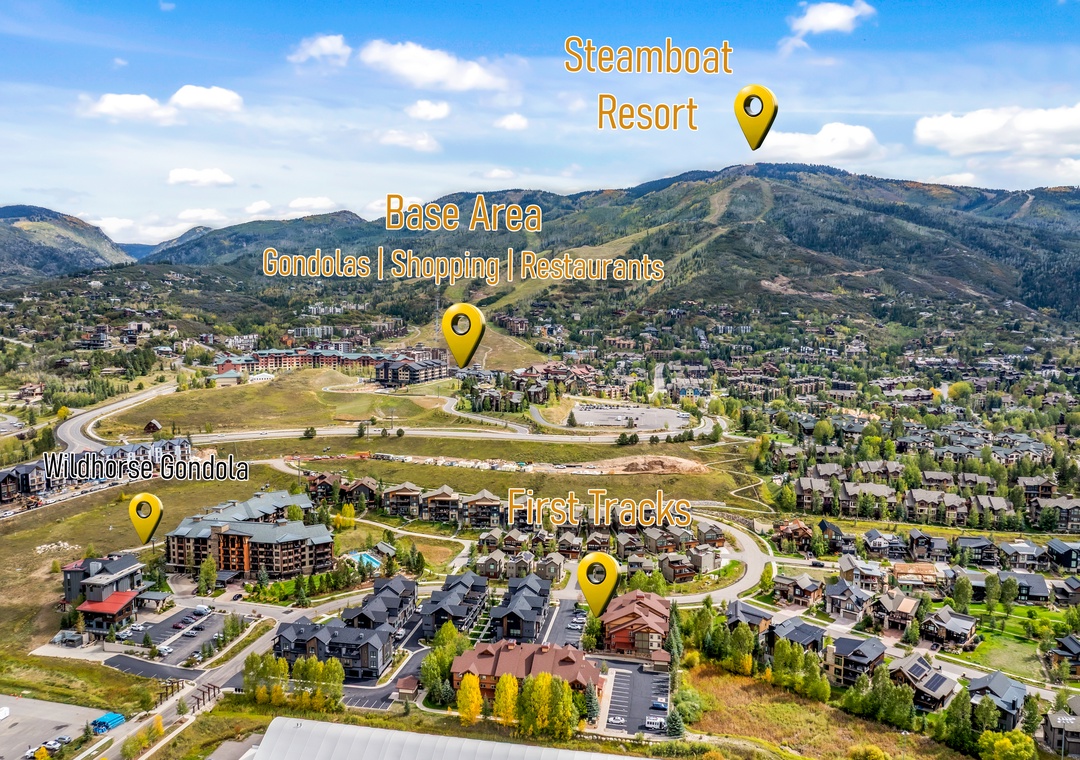 An aerial view of the resort area, set amid rolling hills and mountains—the surrounding neighborhood blends vacation condos, green spaces, and proximity to base amenities.
