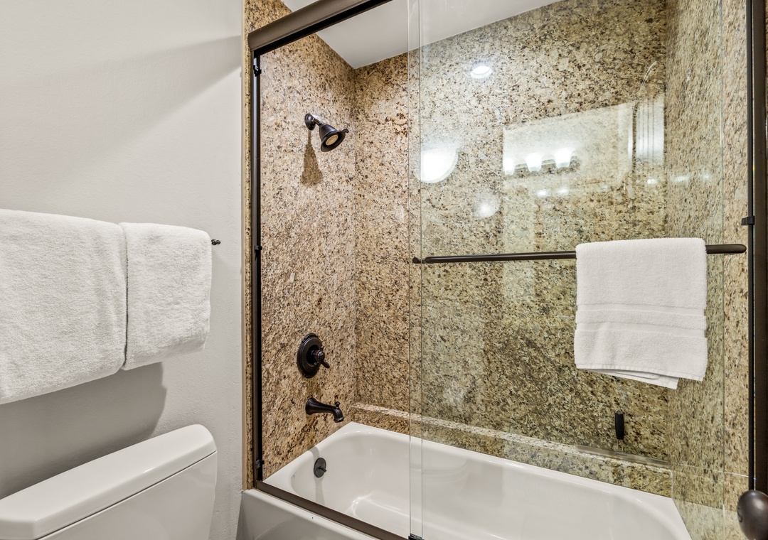 Unwind in your granite-lined bathroom, where soft towels await and a spacious tub beckons for relaxing soaks after your adventures.