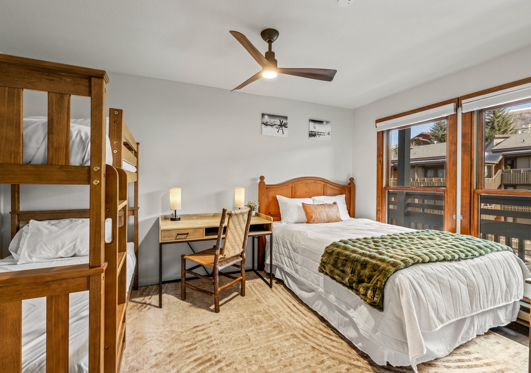 Your spacious bedroom features a comfy queen bed and sturdy bunk beds, perfect for families or groups sharing adventures.