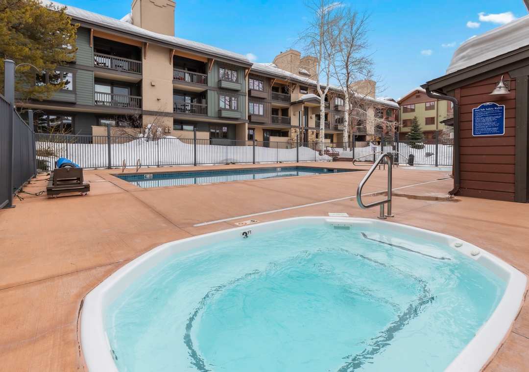 Step outside to your private resort-style retreat, where a sparkling hot tub and pool await under sunny skies—perfect for unwinding after a day of mountain adventures.