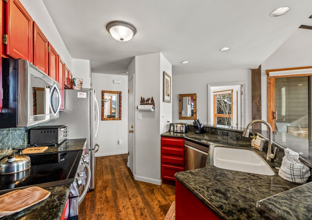 Your gourmet kitchen features rich cherry cabinets, granite counters, and stainless steel appliances, perfect for creating memorable meals during your stay.