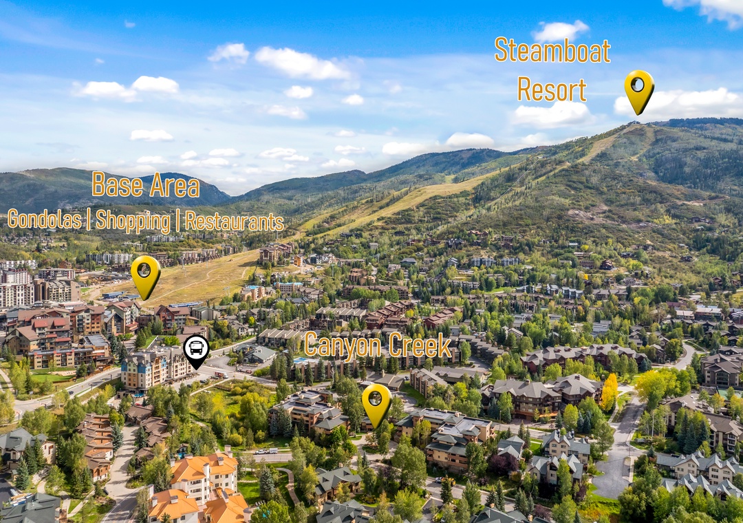 A panoramic view of the surrounding area showing the nearby mountain resort, base village, and local neighborhoods spread across the valley.