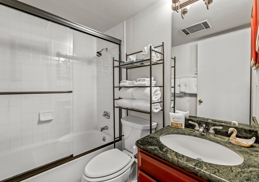 Step into your well-appointed bathroom with granite counters, spacious tub-shower combo, and thoughtfully organized towel storage for your comfort.