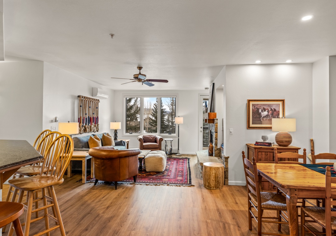 Relax in your spacious living area with warm wood floors, cozy leather seating, and thoughtful rustic touches that create the perfect mountain retreat atmosphere.