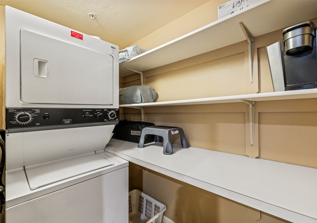 Your laundry stays fresh and convenient with this well-organized space featuring modern appliances and ample shelving for supplies.