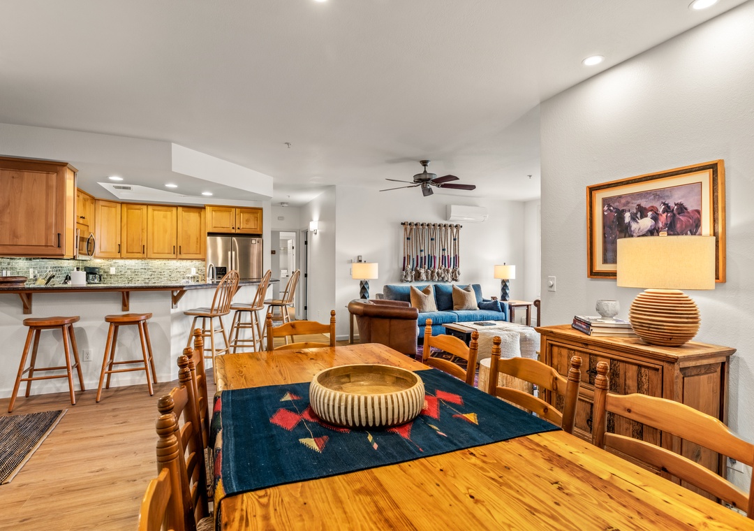 Gather around this beautiful wooden dining table while staying connected to the kitchen and living areas in this open, inviting space.