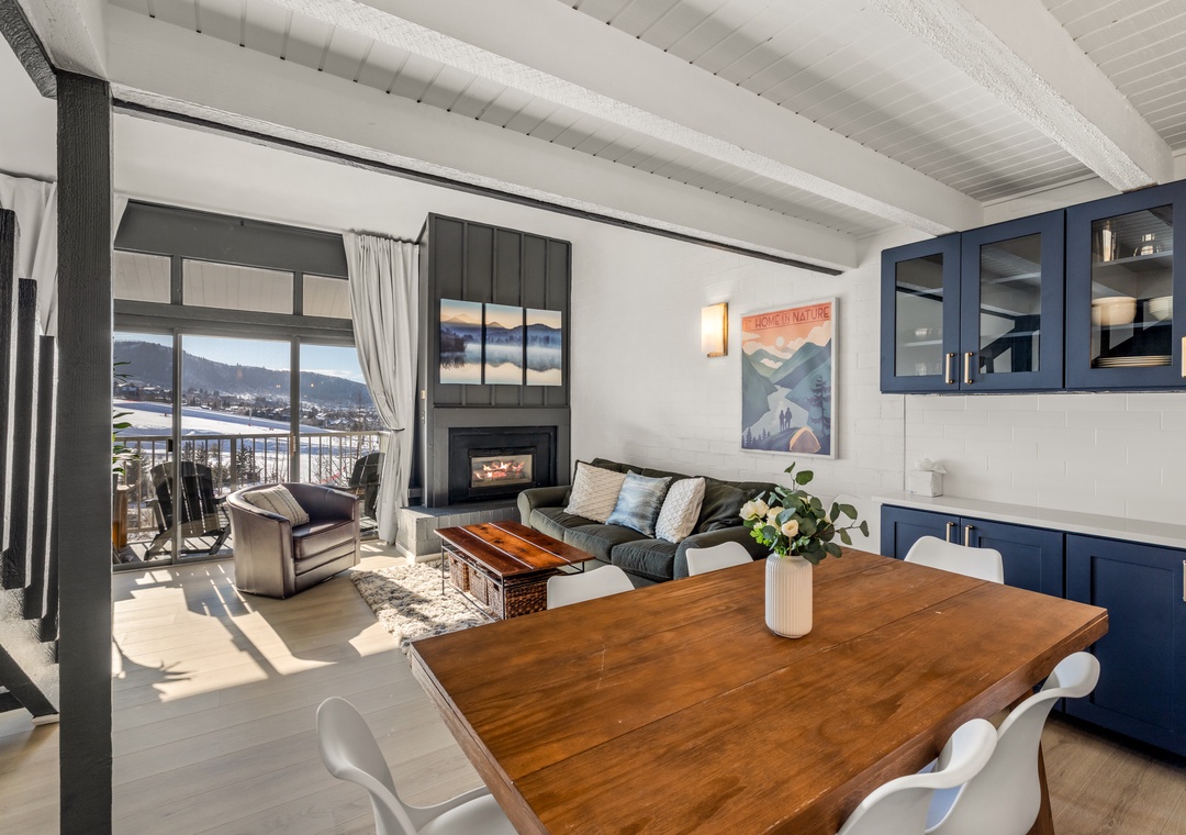 Cozy up in this stylish open-plan space where you'll find a crackling fireplace, comfortable seating, and stunning mountain views through your private balcony.