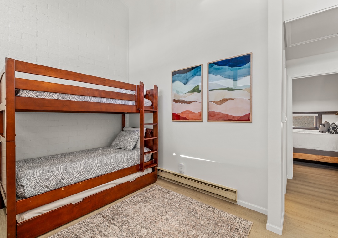 Non-conforming bedroom in the loft area offering sturdy bunk beds along with a comfortable seating area for relaxing.