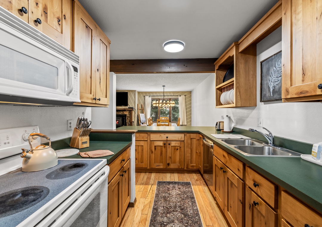 Your fully equipped kitchen welcomes you with warm wood cabinets, ample counter space, and everything needed to prepare memorable meals during your stay.