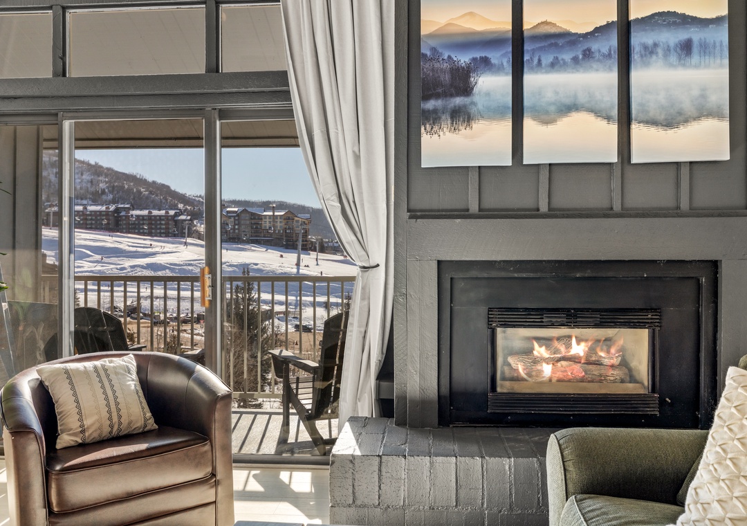 Cozy up by the fireplace while enjoying mountain views from your private balcony in this stylish retreat.