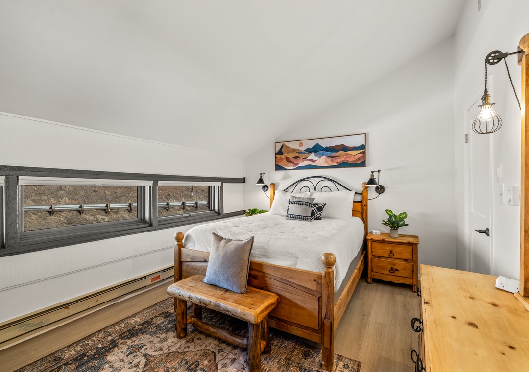 Drift off peacefully in your cozy wooden bed in the upstairs bedroom, surrounded by warm rustic charm and thoughtful touches that make this space truly yours.