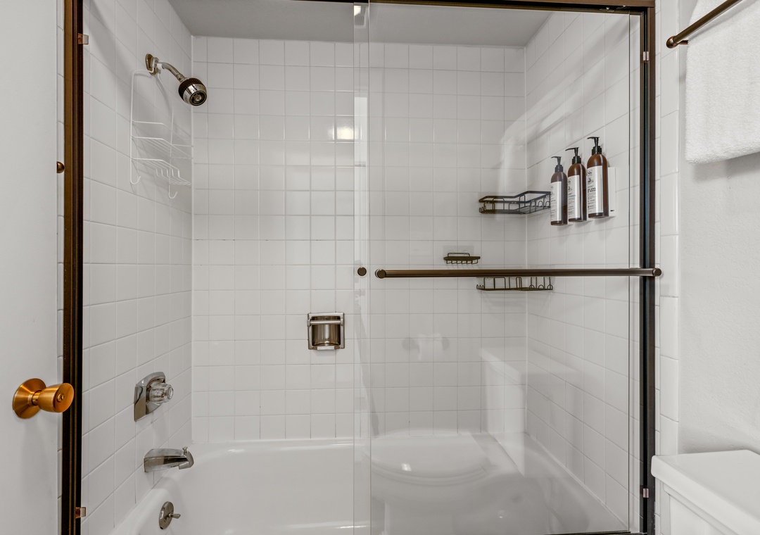 Step into your spotless bathroom with a luxurious walk-in shower featuring premium amenities and thoughtful storage for your toiletries.