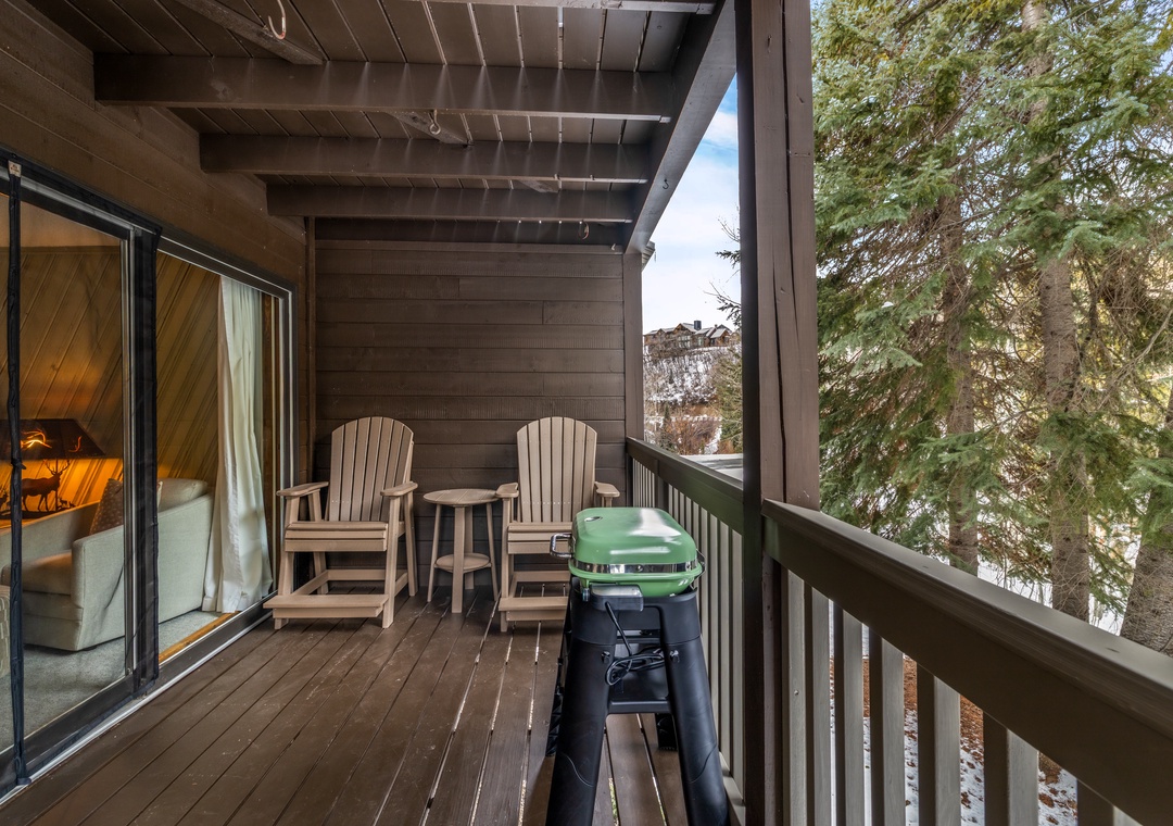 Relax on your private balcony with cozy seating and your own BBQ grill, surrounded by peaceful mountain views.