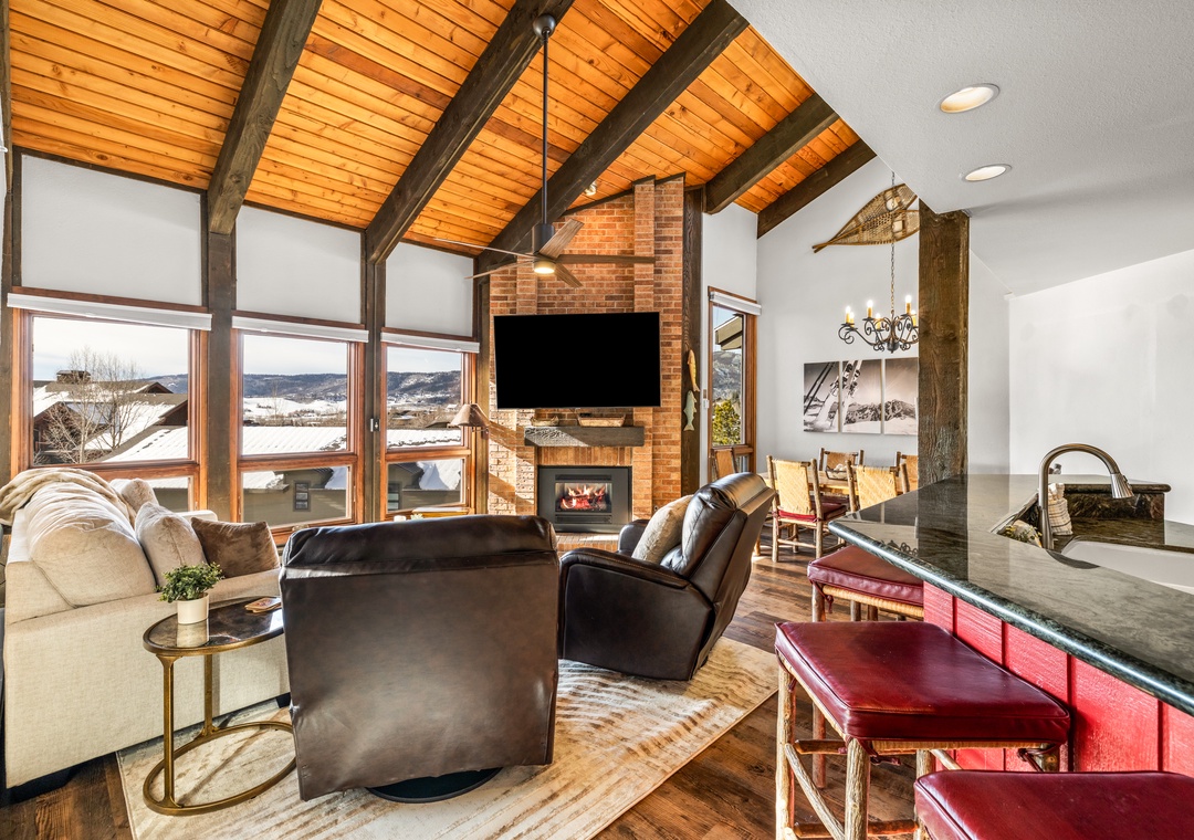Unwind in this stunning living space where leather seating meets soaring wood ceilings and a warm brick fireplace creates the perfect mountain retreat.