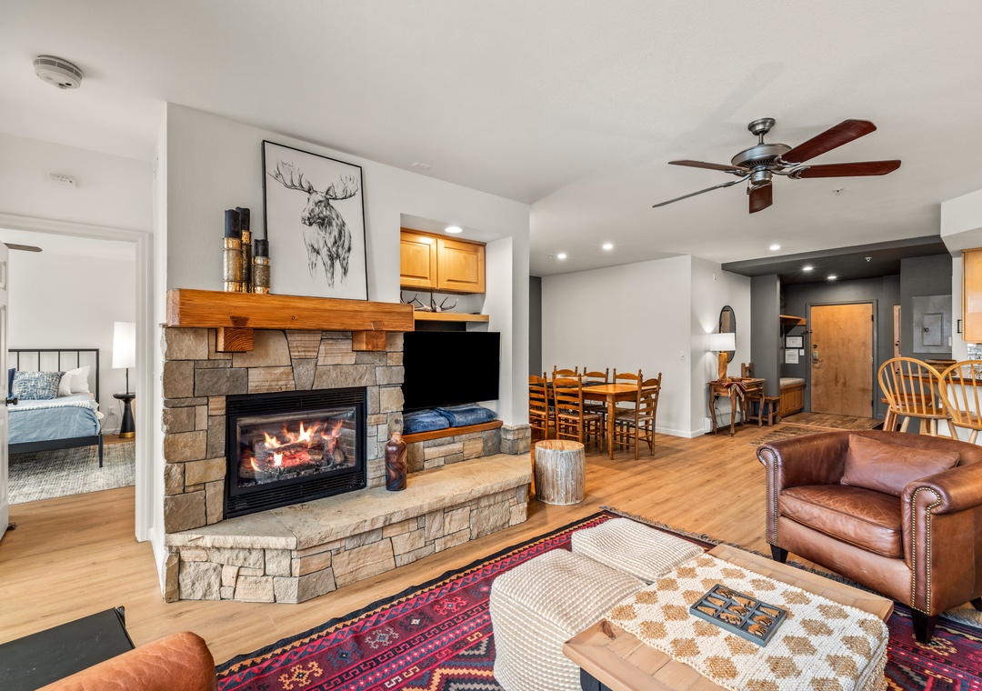 Gather around the crackling stone fireplace in your cozy living space, where warm leather chairs and mountain-inspired decor create the perfect retreat.