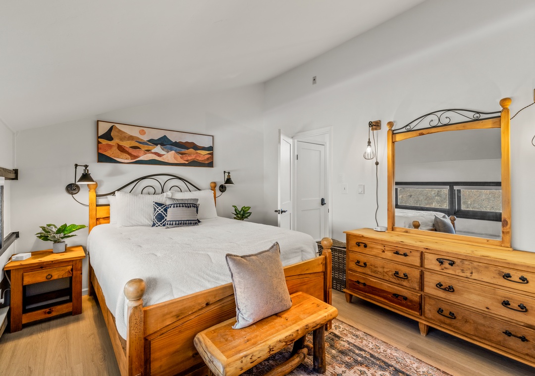 Drift off in your cozy upstairs bedroom retreat, featuring warm wood furnishings, mountain artwork, and thoughtful touches designed for comfort and relaxation