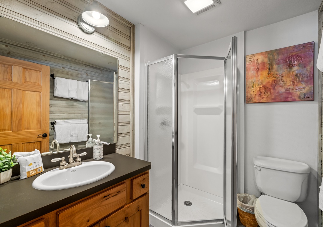 Your shared bathroom features a walk-in shower, elegant vanity with ample counter space, and thoughtful rustic-modern touches for your comfort.