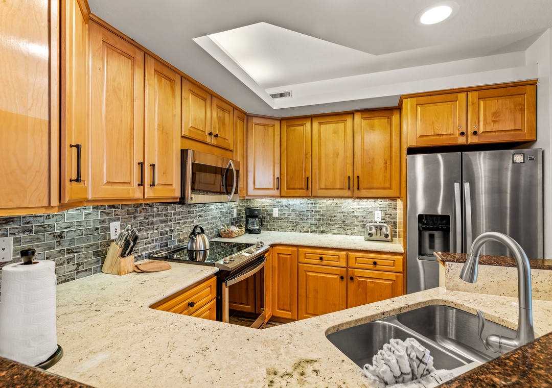 You'll love preparing meals in this fully equipped kitchen with stone counters, stainless appliances, and beautiful tile backsplash.