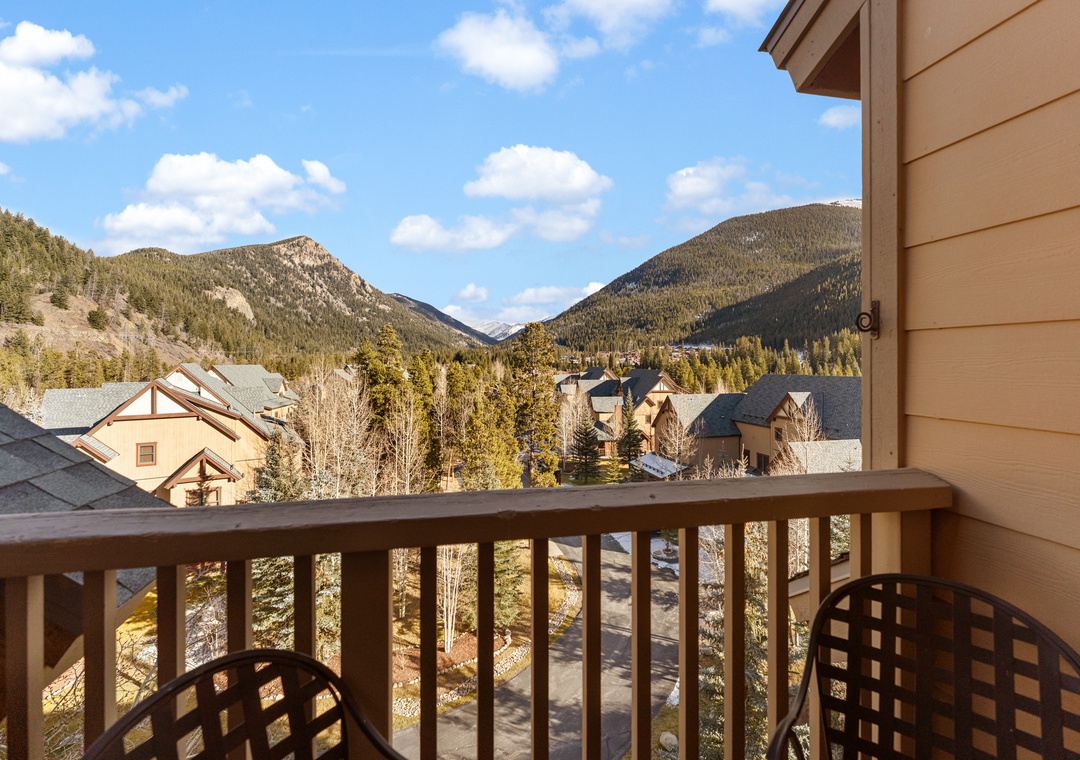 Breathe in the crisp mountain air from your private balcony, where stunning peaks frame your perfect alpine getaway.