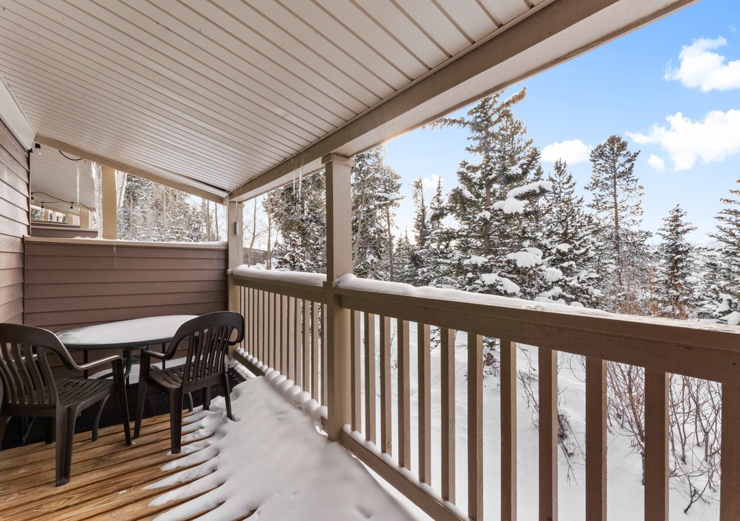 Step onto your private covered balcony and breathe in the crisp mountain air while enjoying stunning snow-covered forest views.