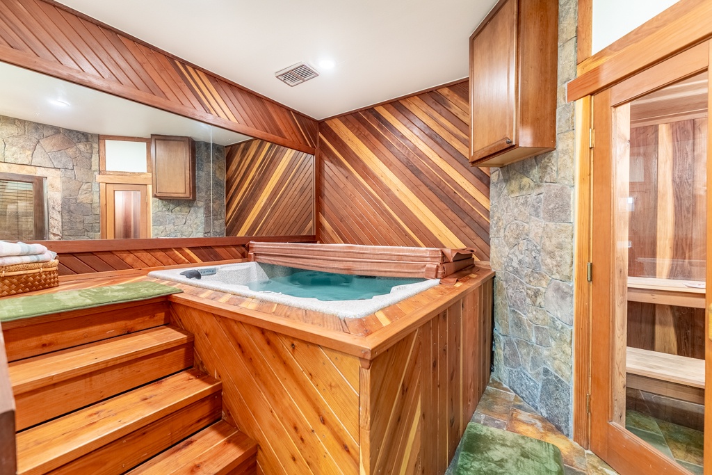 Unwind in your private spa sanctuary with rich cedar hot tub and authentic sauna, creating the perfect wellness retreat.