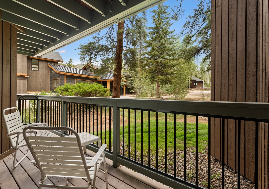 Step out onto your private balcony and breathe in the fresh mountain air, surrounded by towering pines and peaceful views of the surrounding cabins and greenery.