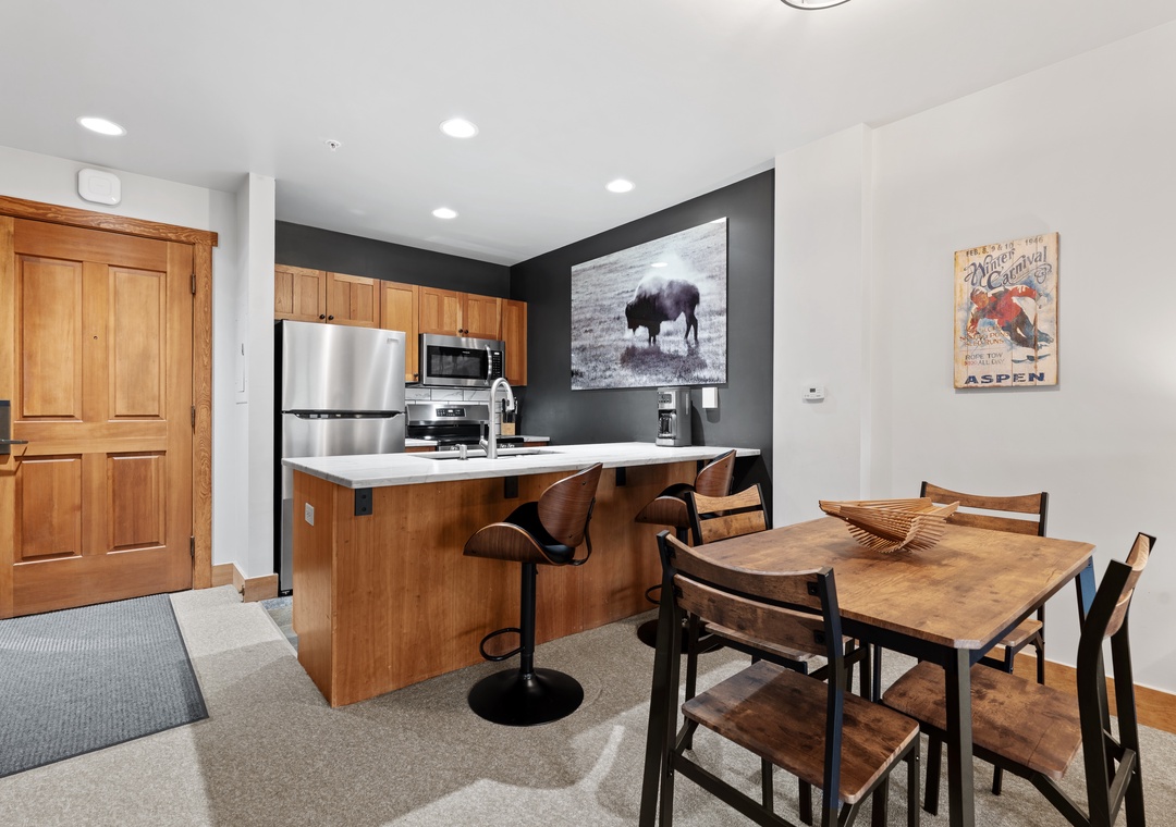 Gather around your private dining table after prepping meals in your fully equipped kitchen, complete with stainless appliances and a breakfast bar for casual moments together.
