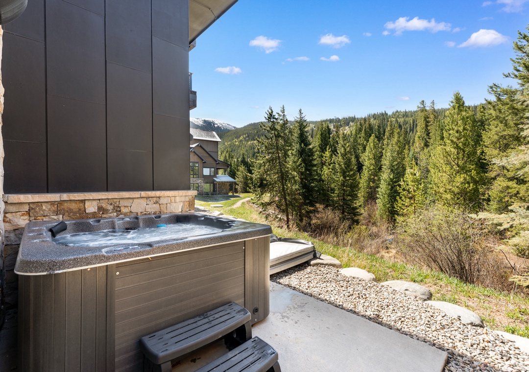 Soak in the bubbling hot tub on your private patio, surrounded by towering evergreens and mountain views that stretch to the horizon.