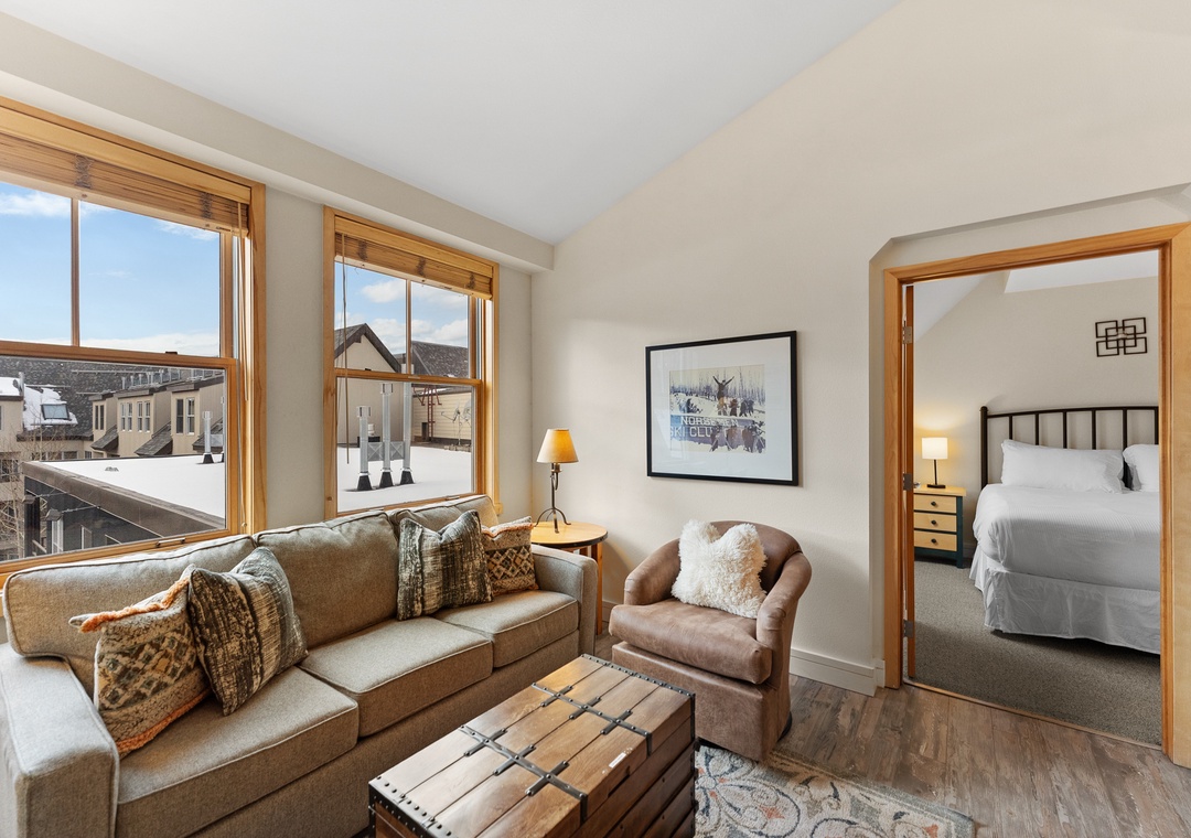 Unwind in your bright living space with plush seating and peek into your cozy bedroom sanctuary.