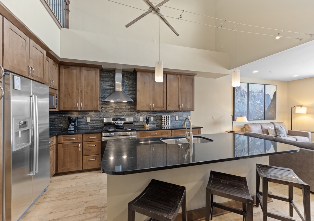 Your gourmet kitchen features granite countertops, stainless steel appliances, and a breakfast bar perfect for morning coffee or casual meals.