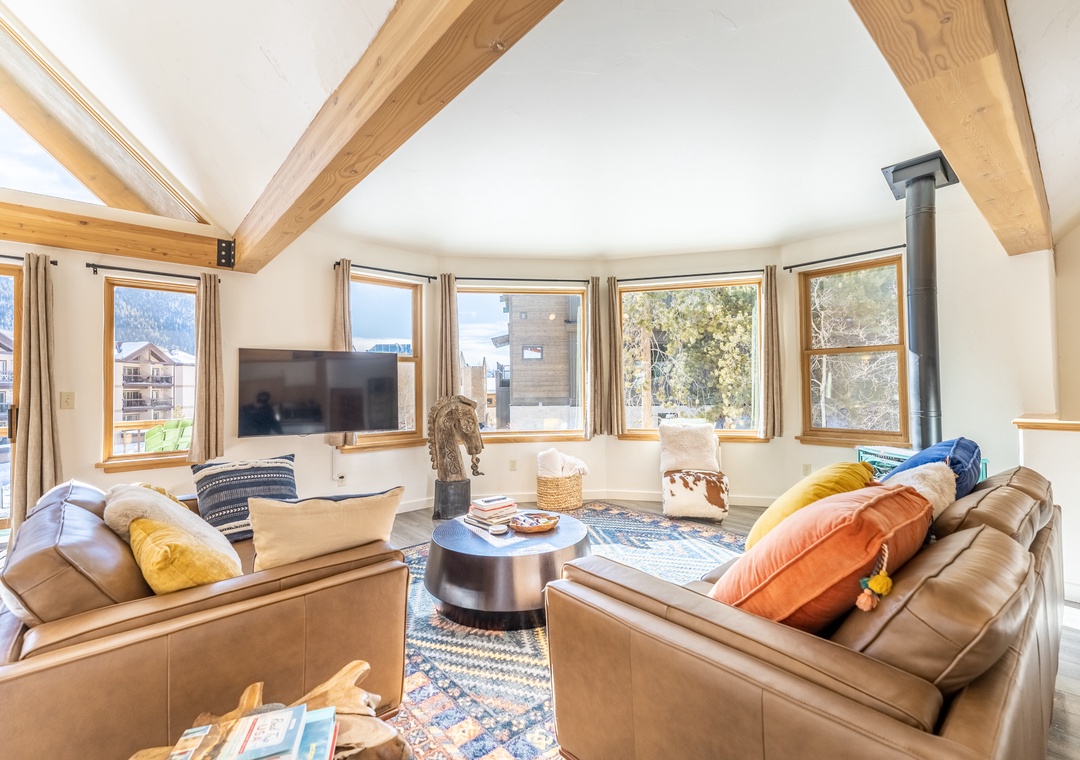 Sink into plush leather seating surrounded by panoramic windows that flood your space with natural light and stunning mountain views.