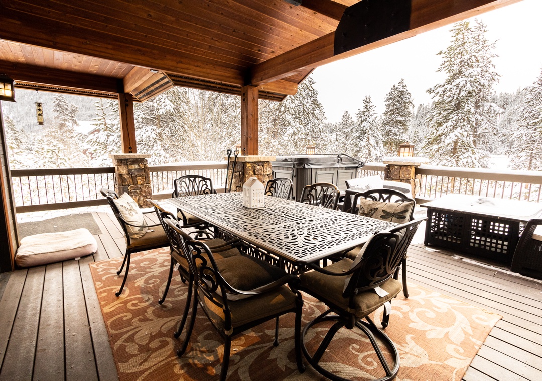 Your covered deck becomes a winter wonderland dining space, where you'll enjoy meals surrounded by snow-dusted trees and peaceful mountain views.