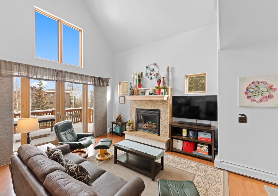Unwind in your spacious living room where soaring ceilings and a cozy fireplace create the perfect mountain retreat atmosphere.