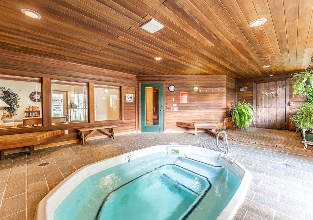 Soak your stresses away in this stunning cedar-lined hot tub room with warm wood accents and peaceful atmosphere.