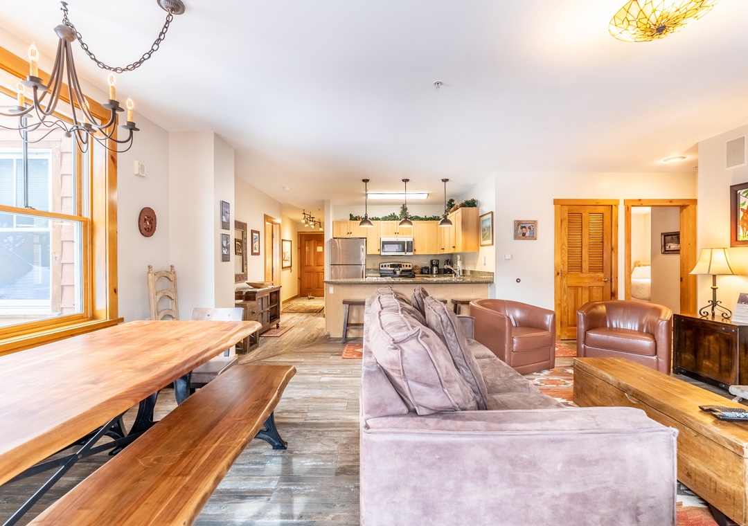 Relax in your spacious open-concept living area where warm wood accents and comfortable seating create the perfect mountain retreat atmosphere.