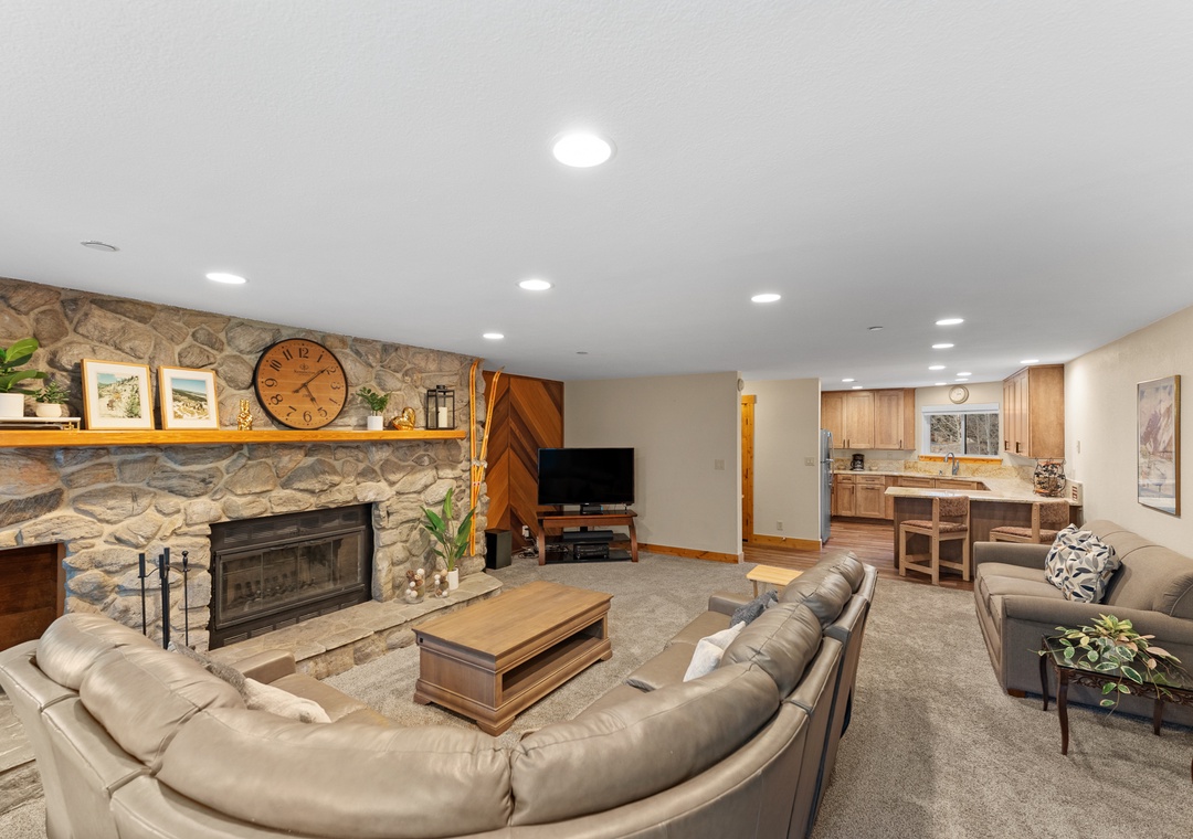 Sink into plush leather seating by your cozy stone fireplace, while the open kitchen invites culinary adventures in this spacious retreat.