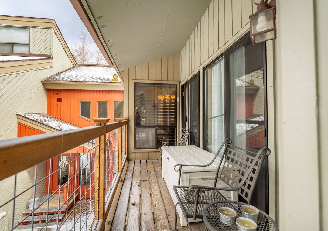 Your private balcony offers a peaceful retreat with comfortable seating and charming neighborhood views.