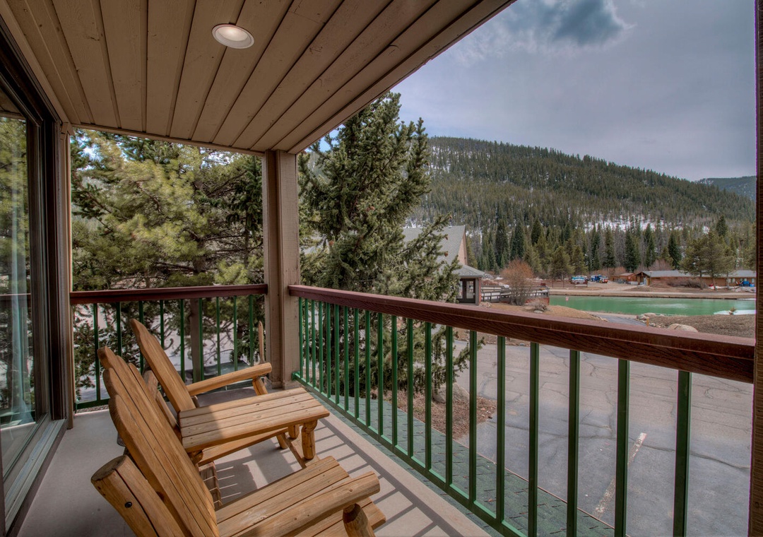 Unwind on your private balcony with mountain vistas and wooden Adirondack chairs, perfect for morning coffee or evening relaxation.
