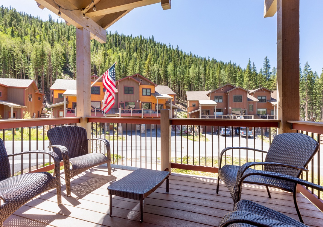 Relax on your private deck with wicker seating while taking in stunning mountain views and charming village scenery below.