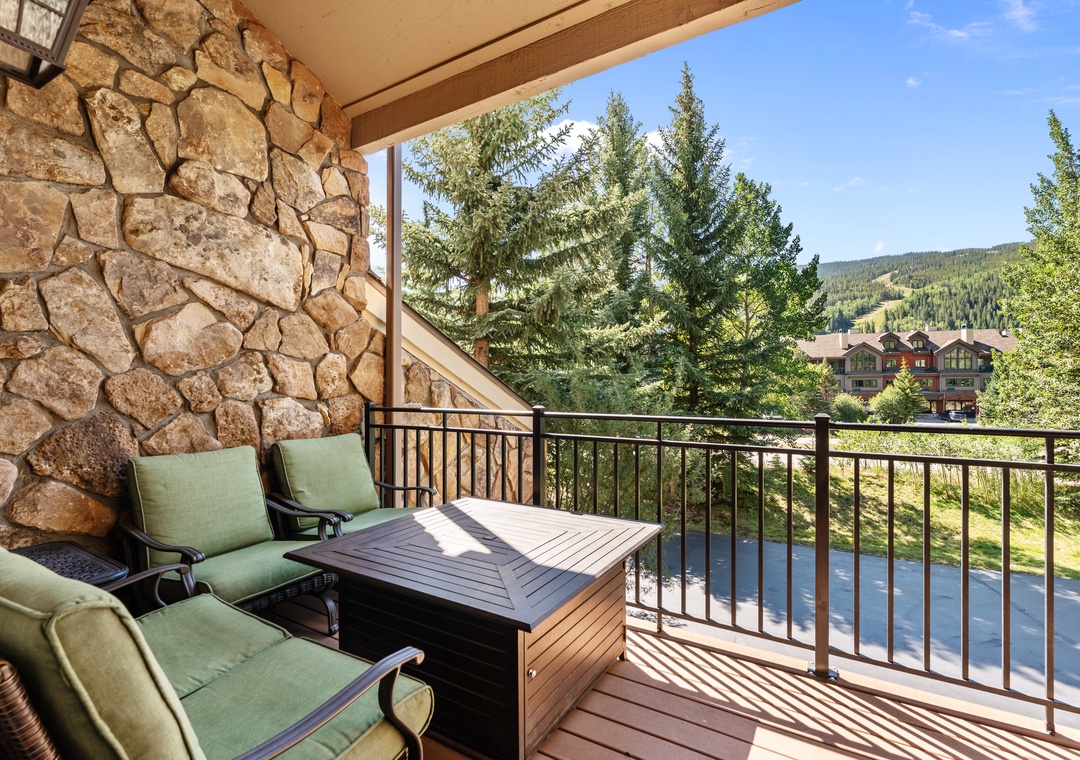 Relax on your private balcony with cushioned seating and sweeping mountain views framed by towering pines—perfect for morning coffee or unwinding after a day of adventure.