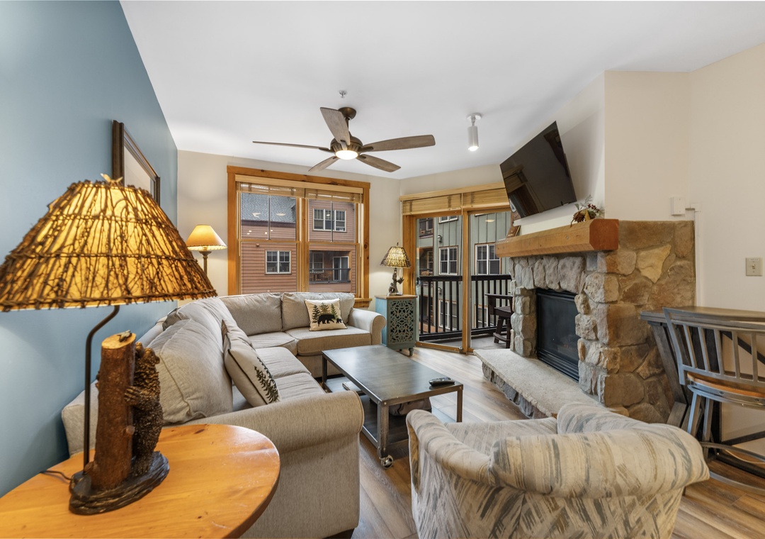 Unwind in your cozy living room with stone fireplace, comfy seating, and mountain lodge charm that makes every evening feel special.