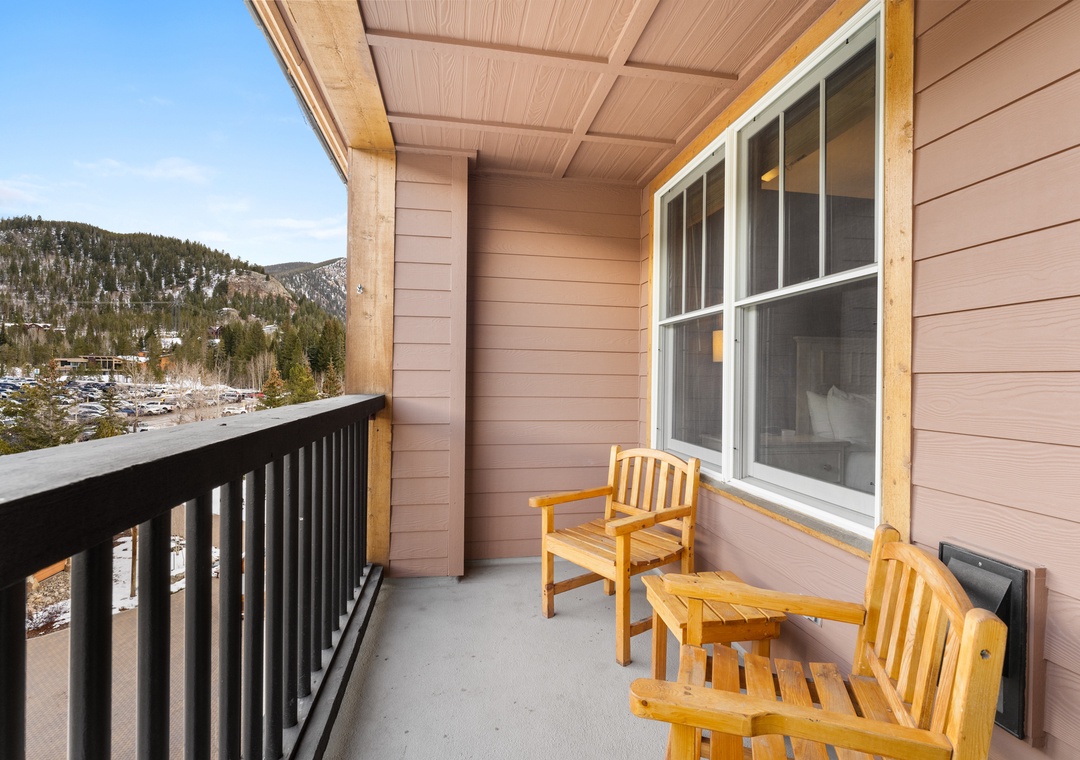 Relax on your private balcony with stunning mountain views, where cozy wooden chairs invite you to unwind with morning coffee or evening cocktails.