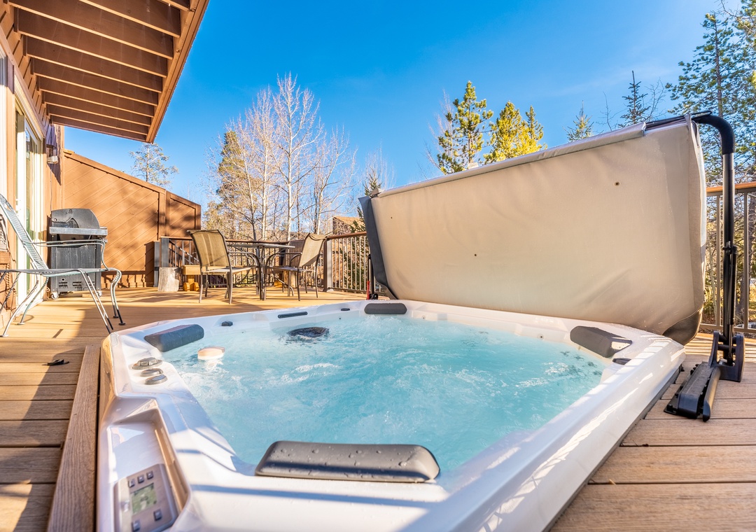 Unwind in your private hot tub on this sunny deck, surrounded by towering pines and mountain views.