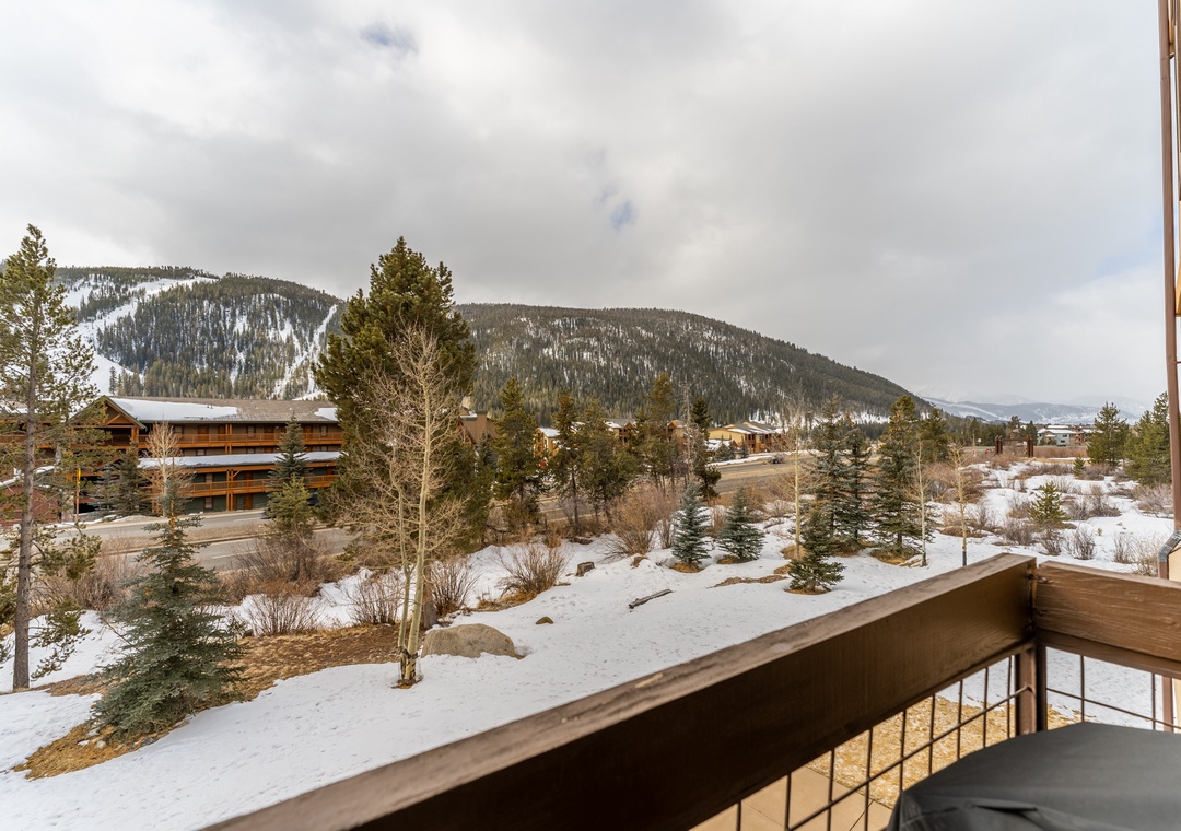 Stunning mountain views frame this peaceful alpine balcony, where snow-dusted peaks create the perfect backdrop for your morning coffee.