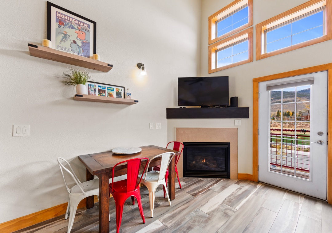 Gather around your cozy dining table by the warm fireplace, where mountain views and modern comfort create the perfect setting for memorable meals together.